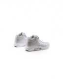 Sneaker laminata con borchie da bimba
