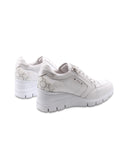 Sneaker zeppa in pelle con zip laterale